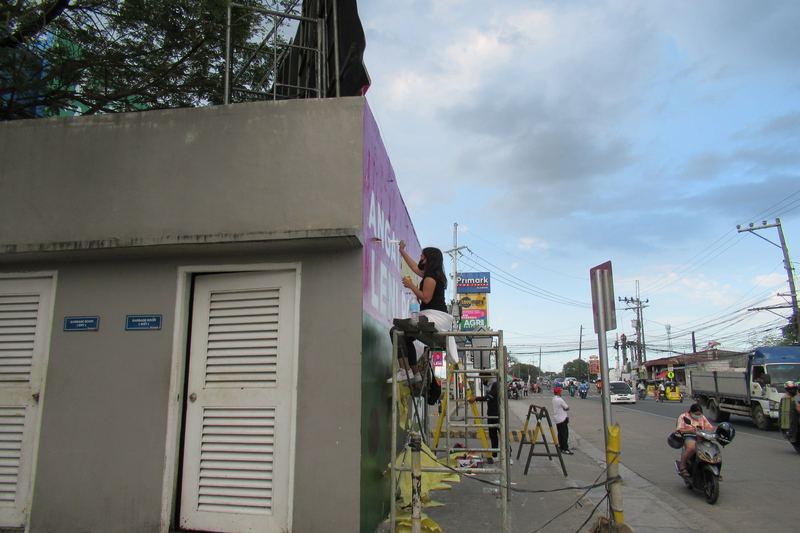 Contractors with scaffolding and ladders on a building